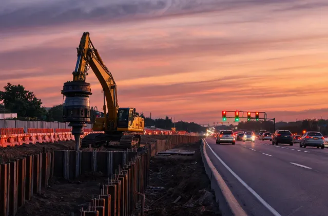 Highway retaining wall pile driving