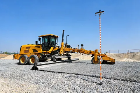 Gravel grader finishing foundation pad